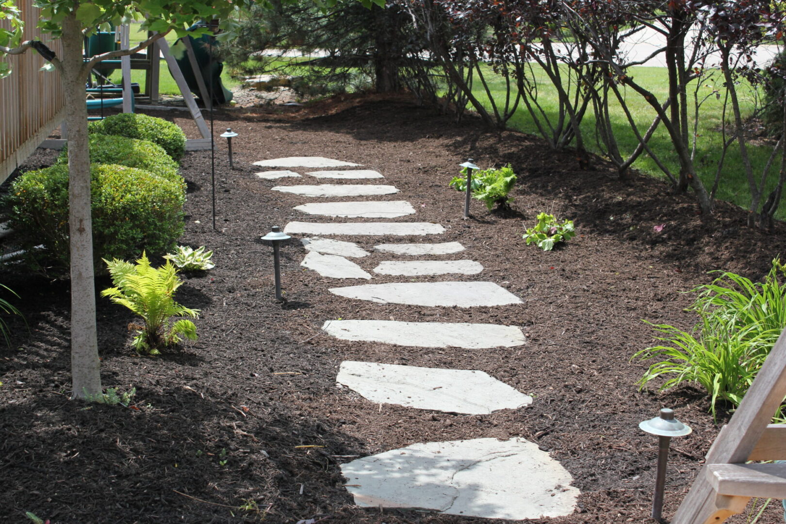 A path with stepping stones in the middle of it.