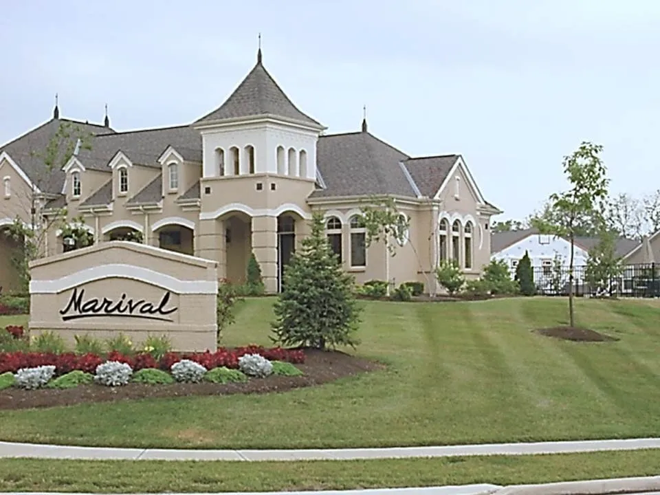 A large house with a lawn in front of it.